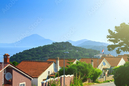 Traditional european Mediterranean architectural style  streets   houses with terracotta roofs  surrounded by cypress  palm  olive  pine trees  on coast azure sea. Location of the prestigious estates