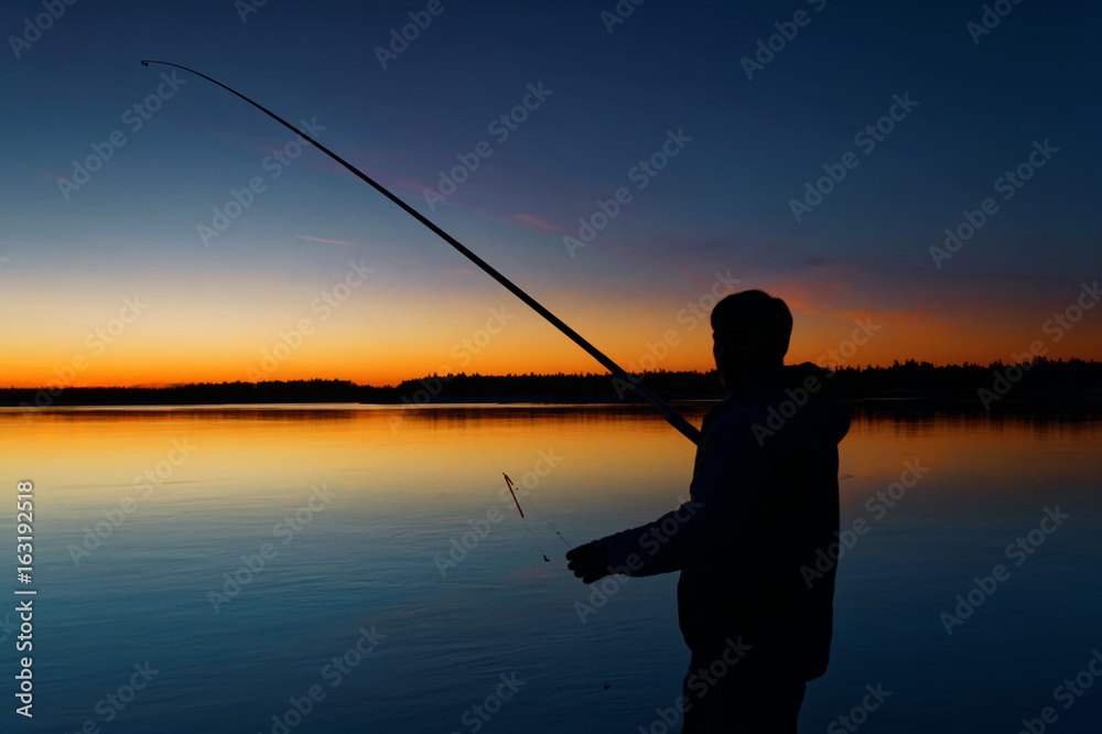 Fisherman on sunset background. Russia, Yamal.