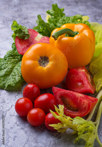 Fresh red and yellow tomatoes, sweet pepper and lettuce