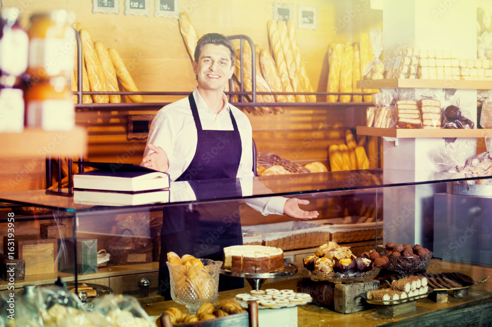 Cafe staff offering fancy and sponge cakes