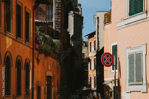 Fototapeta Naklejka Na Ścianę i Meble -  Narrow street in Rome, Italy at summer