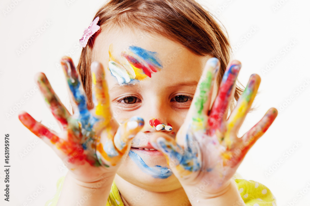 Beautiful little child girl and the painted hands. (art, people, childhood, color, drawing concept) Beautiful little child girl and the painted hands. (art, people, childhood, color, drawing concept)