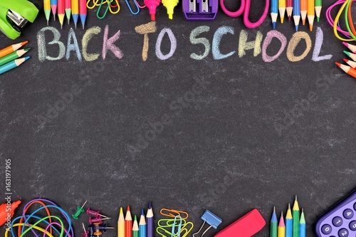 School supplies double border with Back To School written in colorful chalk with against a chalkboard background