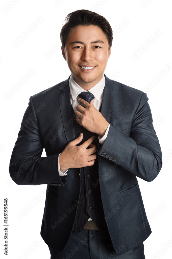 Handsome young entrepreneur with a smile standing against a white background wearing a blue suit, tie and vest. Handsome young entrepreneur with a smile standing against a white background wearing a blue suit, tie and vest.