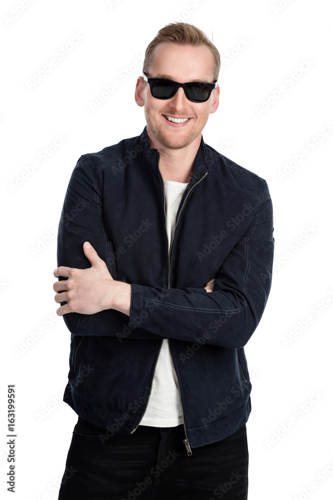 Trendy cool man wearing dark sunglasses and a leather jacket standing with a big smile against a white background looking at camera. Trendy cool man wearing dark sunglasses and a leather jacket standing with a big smile against a white background looking at camera.