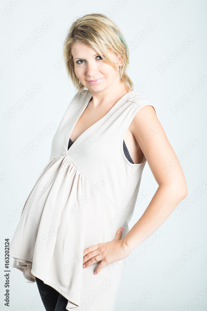 Beautiful young pregnant woman with shopping bags posing. Pregnancy, motherhood, sale, people and expectation concept. Isolated on background. Beautiful young pregnant woman with shopping bags posing. Pregnancy, motherhood, sale, people and expectation concept. Isolated on background.