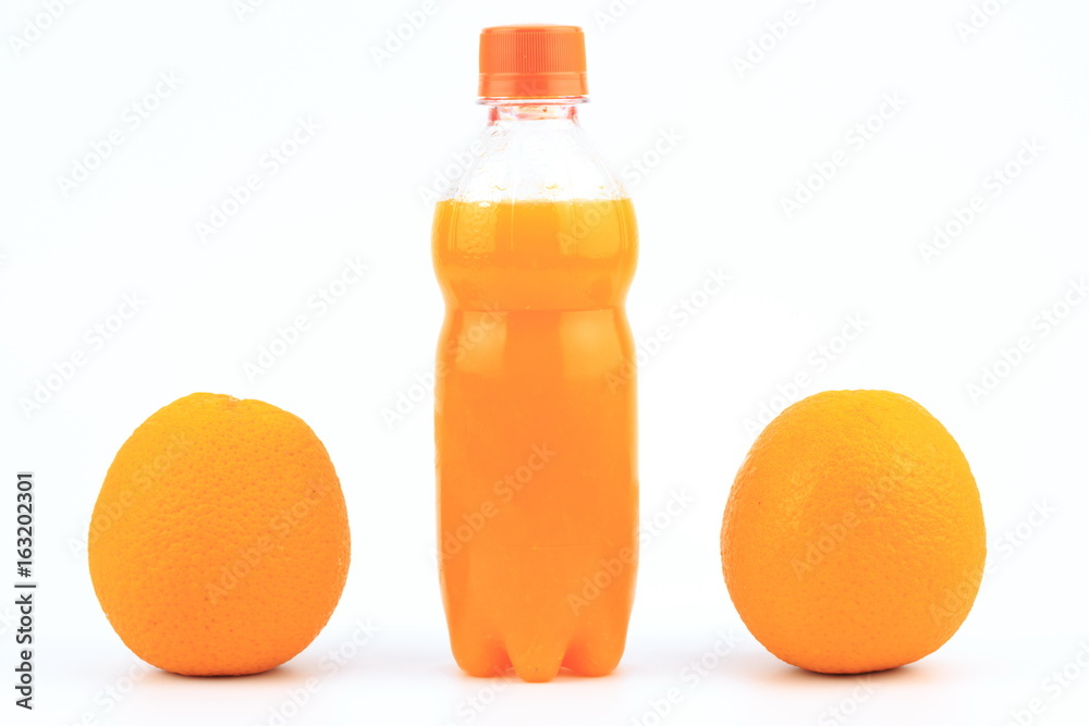Orange juice in plastic bottle on white background with orange fruit Orange juice in plastic bottle on white background with orange fruit