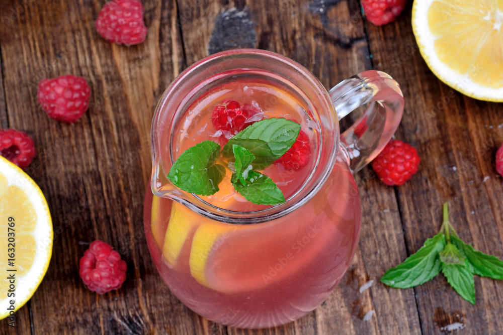 Fresh raspberry lemonade with mint in a pitcher Fresh raspberry lemonade with mint in a pitcher