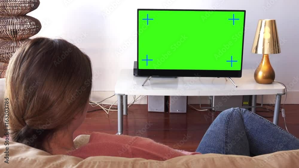 Zoom In Woman Watching Green Screen Television Lying On Couch. Young