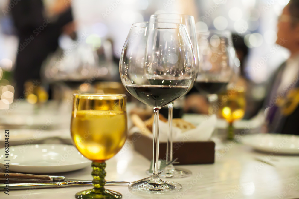 Blurry background of wine glass set up on the table in luxury dinner party. Blurry background of wine glass set up on the table in luxury dinner party.