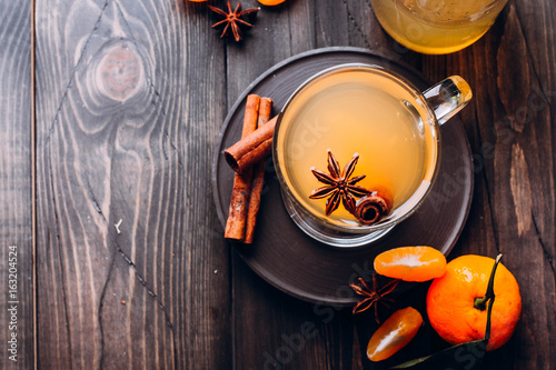 Fresh Drinks with spicy,citrus fruits and cinnamon in glass on wooden background table. Top view, copy space