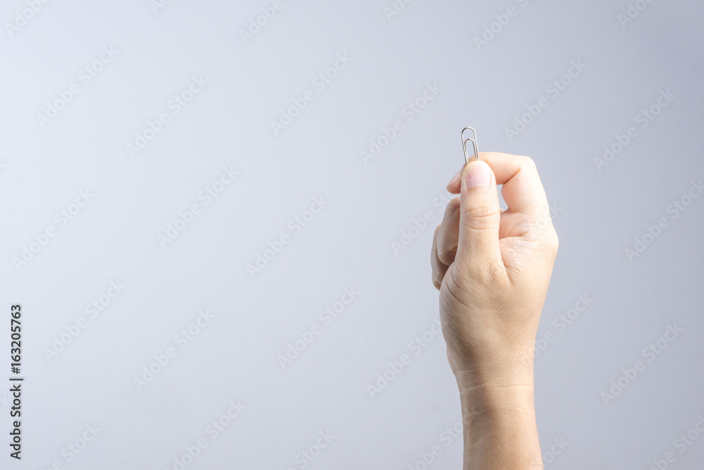 Hand holding paper clip Hand holding paper clip