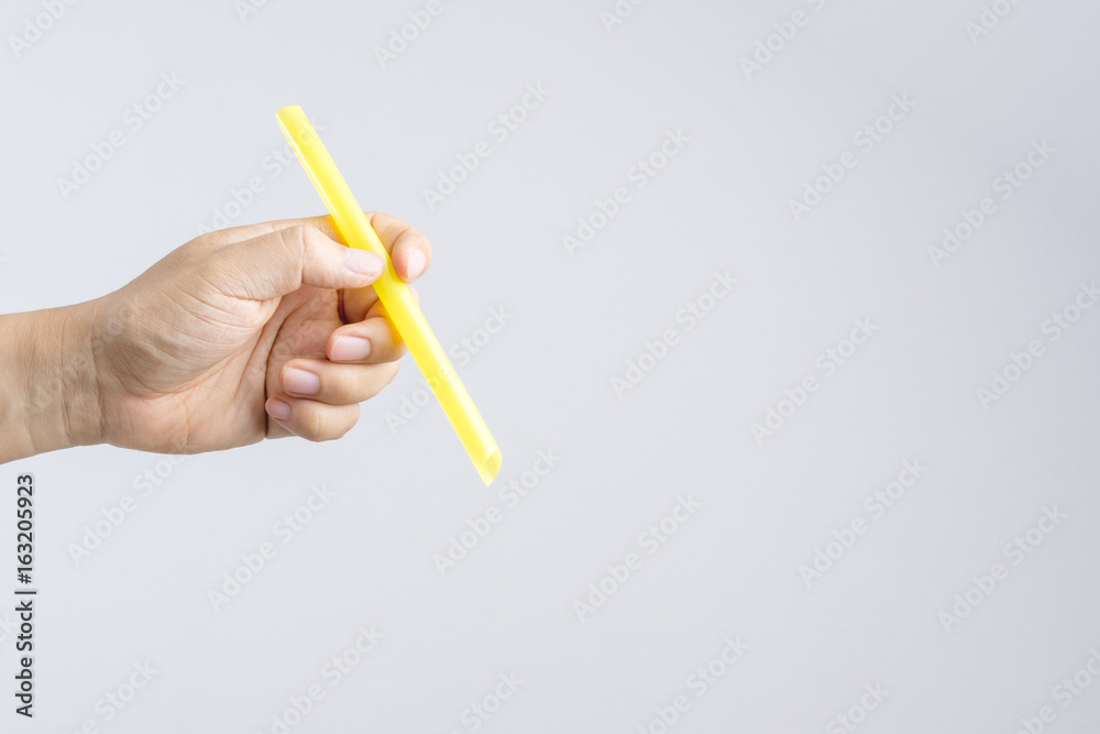 Hand holding a big or extra large drinking straw Hand holding a big or extra large drinking straw