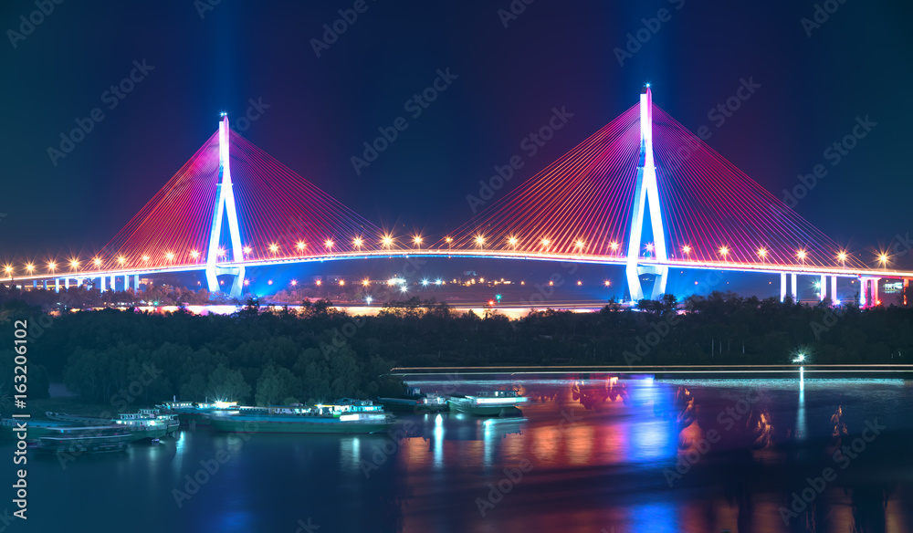 Can Tho cable bridge at night shimmering colorful coupled river banks serving traffic in the Mekong Delta Can Tho cable bridge at night shimmering colorful coupled river banks serving traffic in the Mekong Delta