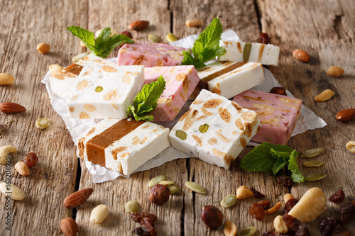 French fresh nougat with nuts and pumpkin seeds close-up. horizontal photo