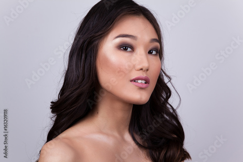 Portrait of a beautiful asian woman with naked shoulders.