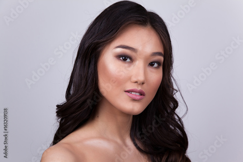 Portrait of a beautiful asian woman with naked shoulders.