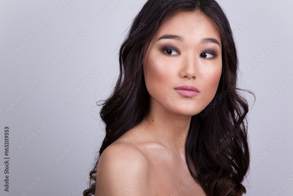 Portrait of a beautiful asian woman with naked shoulders.