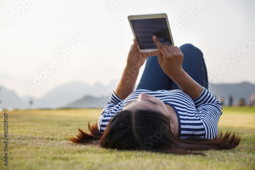 Asia woman using tablet outdoor.