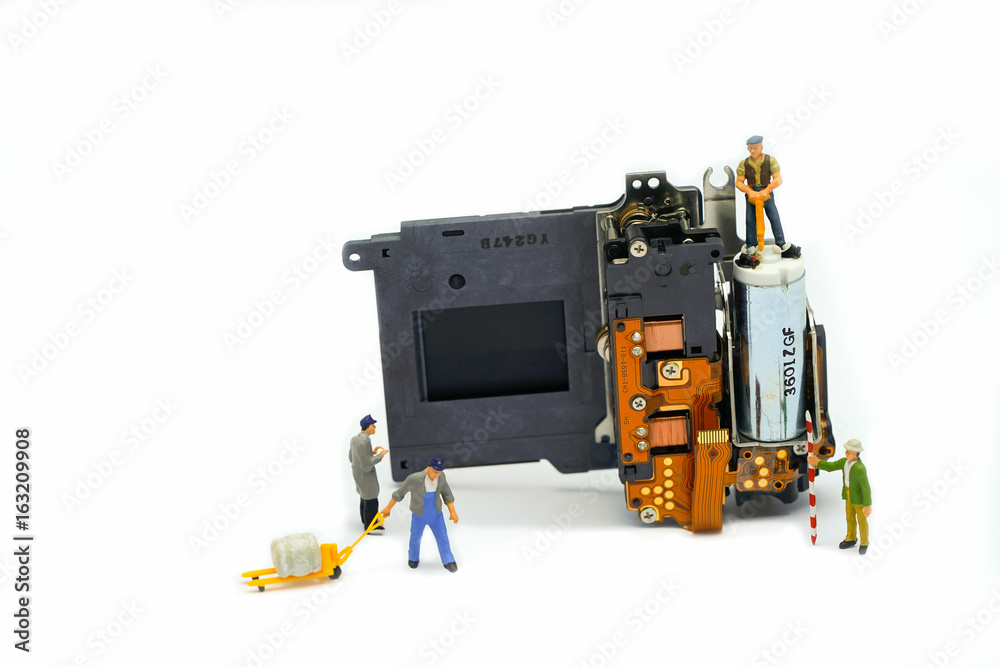 Engineer and technician Minitures are fixing camera shutter assembly Engineer and technician Minitures are fixing camera shutter assembly