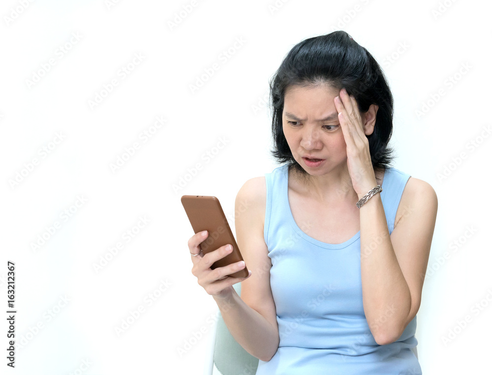 Headshot shocked stunned middle edge women getting bad news while talking on mobile phone isolated on white background. Sad Asian housewife reading a message containing serious or sad news, copy space Headshot shocked stunned middle edge women getting bad news while talking on mobile phone isolated on white background. Sad Asian housewife reading a message containing serious or sad news, copy space