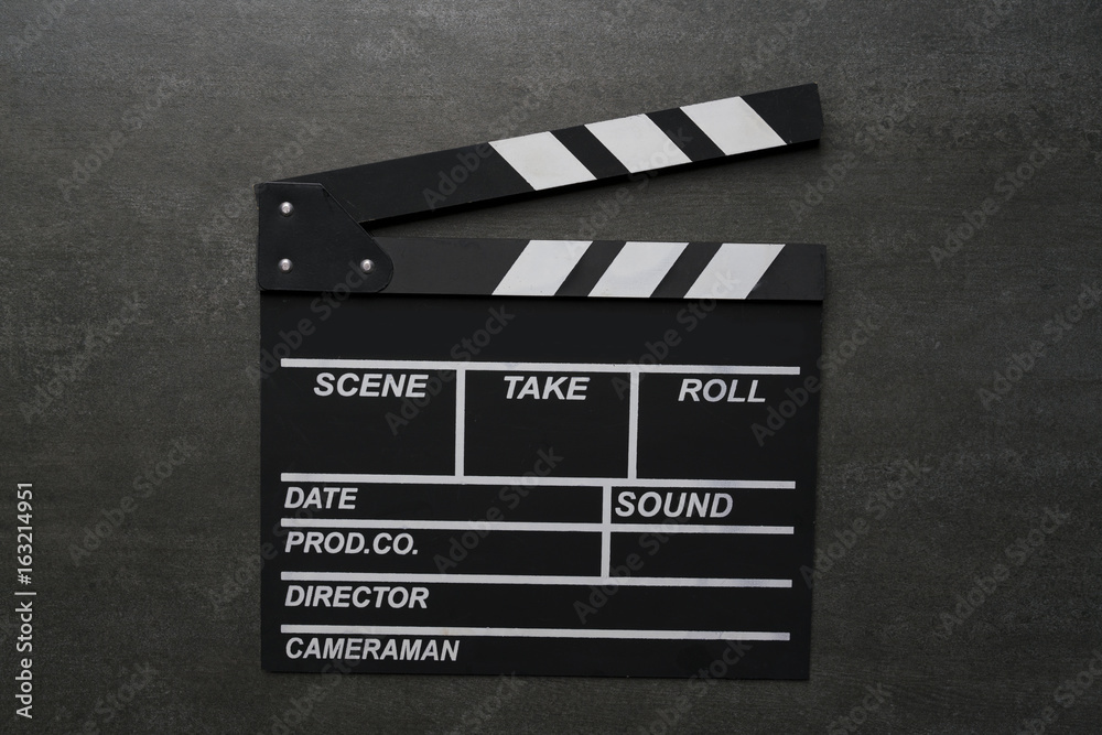 movie clapper on black table