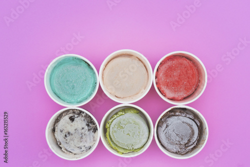 Top view Ice cream flavors in cup on pink background