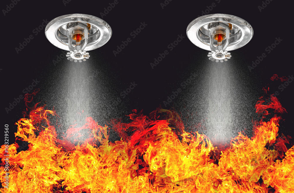 Image of Fire Sprinklers Spraying with fire background. Fire sprinklers are part of an overall safety protocol for fire and life safety. - obrazy, fototapety, plakaty 
