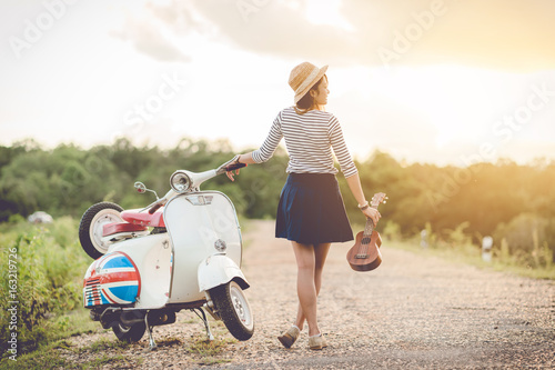 tourist and classic scooter on roadway