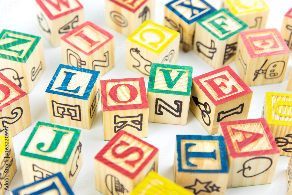 wooden toy cubes are used to create the word love,Love concept or valentine day. wooden toy cubes are used to create the word love,Love concept or valentine day.