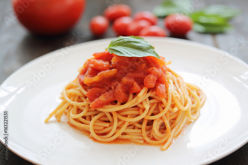 spaghetti with tomato sauce and Basil in dark wooden background