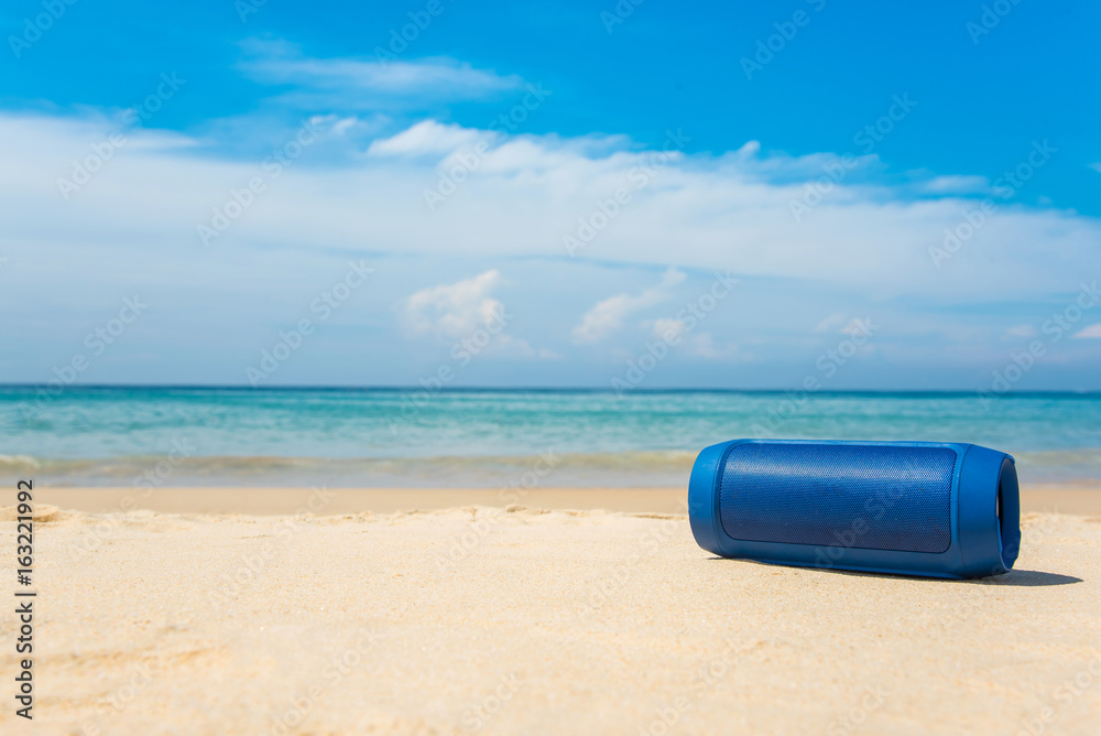 Portable wireless speakers on the beach and blue sky. Portable wireless speakers on the beach and blue sky.