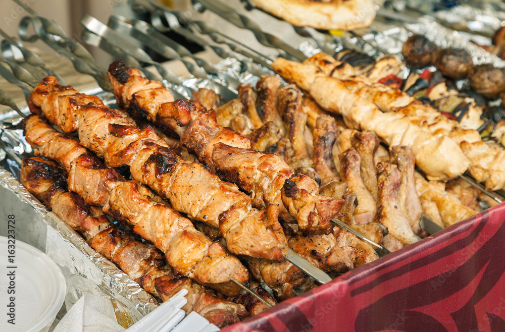 Many different kebab meat on a metal skewers closeup shot