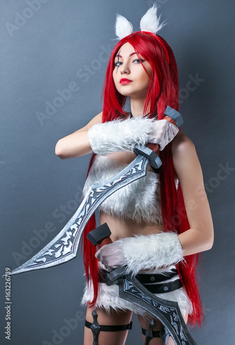 Beauty Fashion Model Girl with red wig and swords on gray background. Cosplay Character from game photo