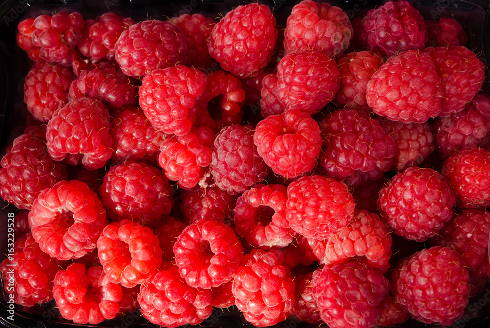 Fresh raspberries as background
