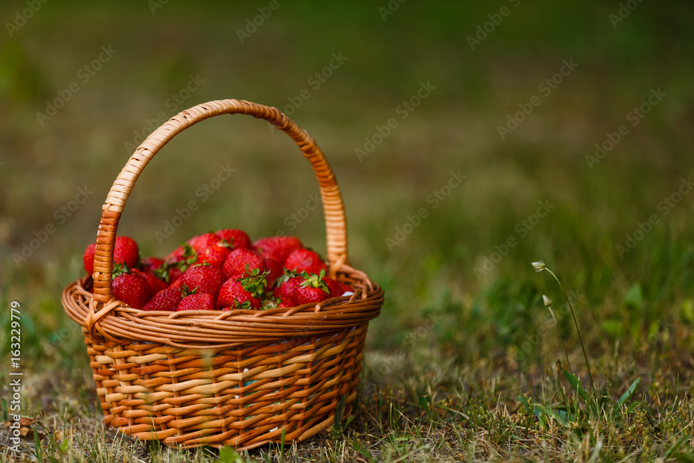 Ripe sweet strawberries in wicker basket