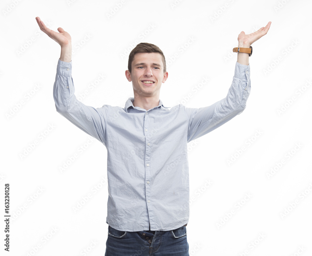 Young happy man showing by hands on a gray background. Ideal for banners, registration forms, presentation, landings, presenting concept. Young happy man showing by hands on a gray background. Ideal for banners, registration forms, presentation, landings, presenting concept.