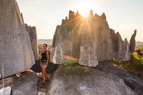 Beautiful tourist on an excursion in the unique limestone landscape at the Tsingy de Bemaraha Strict Nature Reserve in Madagascar photo