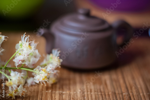  Chinese tea-kettle on a gold background. Chestnut flower and kettle