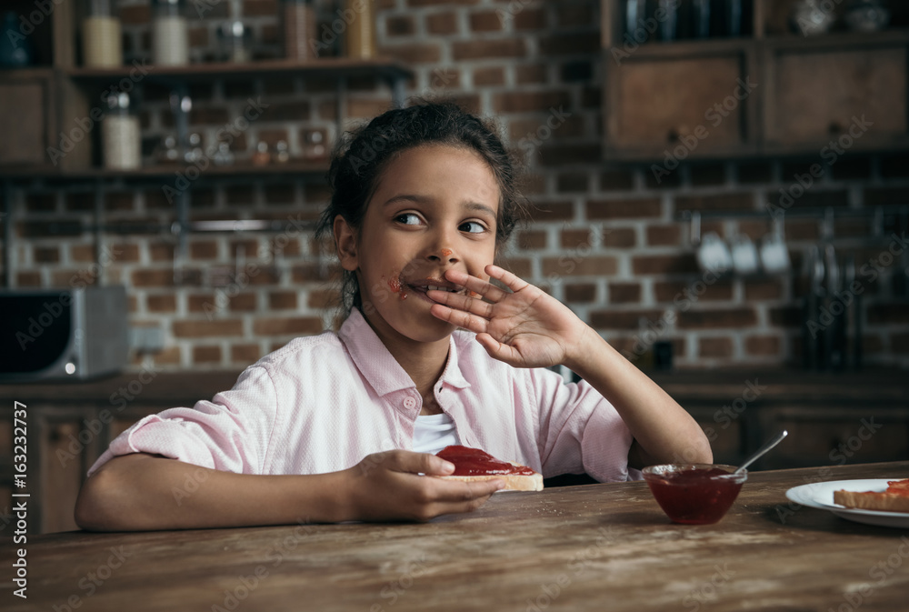 portrait of pensive girl eating toast with jam at home portrait of pensive girl eating toast with jam at home