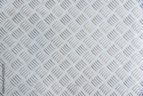 old metal diamond plate as background.