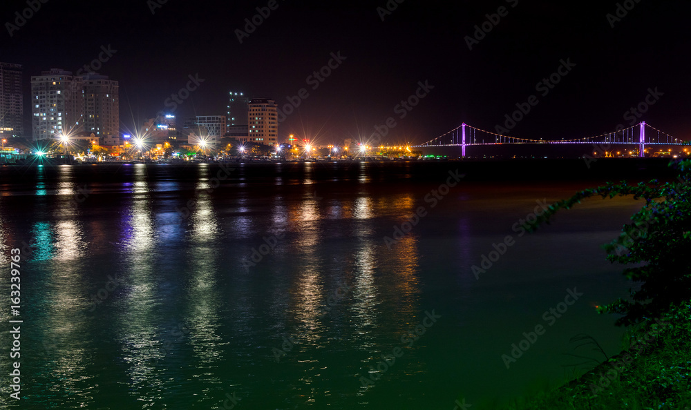 Night view of modern buildings and Han River in Danang city