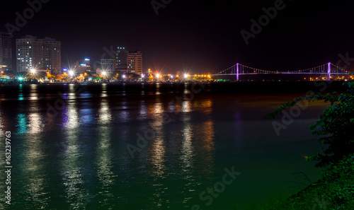 Night view of modern buildings and Han River in Danang city © rostovdriver