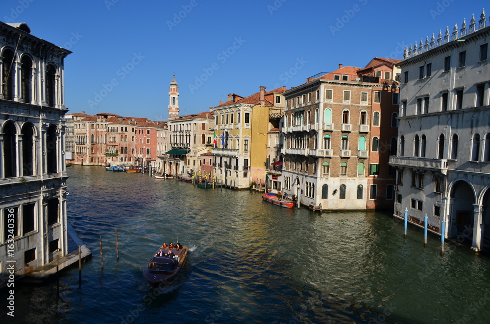 Bridge View of Tourists on a Boat at the Canal in Venice, Italy