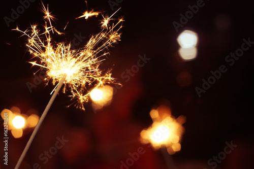 Two Sparklers With Two Girls In The Unfocused Background On A Birthday Celebration In The Summer In Bavaria In Germany