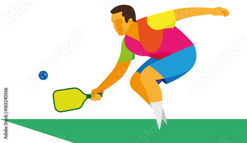 Energetic adult man playing on a court with a racket and ball