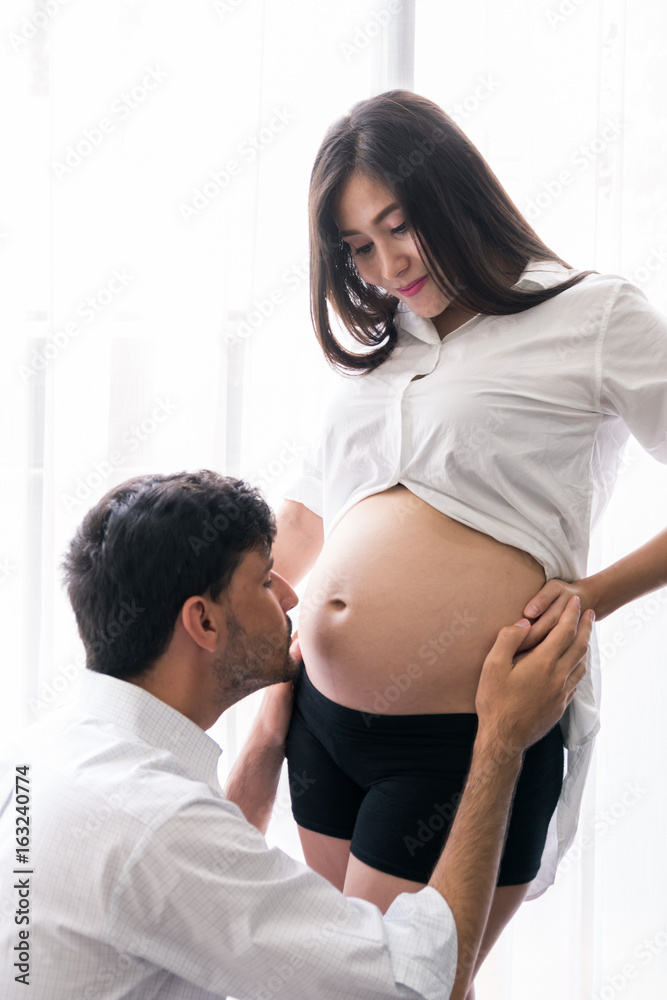 Husband touch baby in belly pregnant mother Husband touch baby in belly pregnant mother