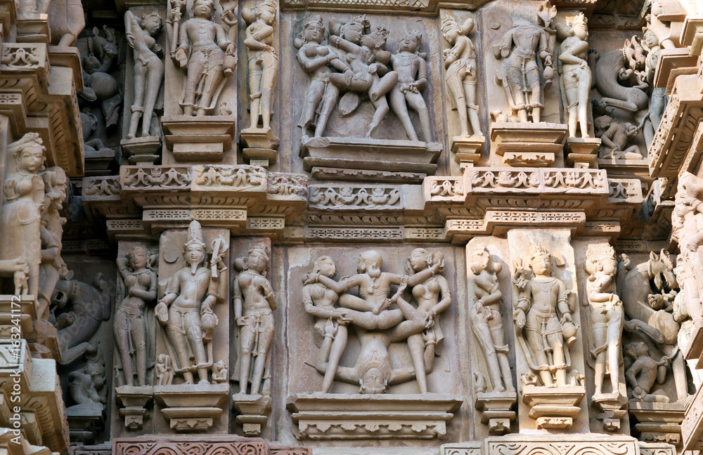 Ancient stone relief with lovers at famous erotic temple in Khajuraho, India