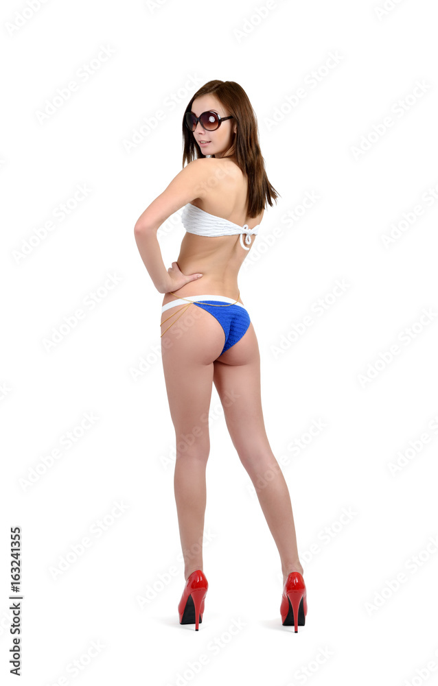 Young girl in bikini and sunglasses posing on white background Young girl in bikini and sunglasses posing on white background