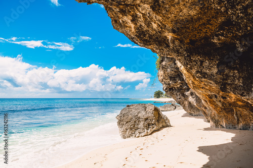 Fototapeta Naklejka Na Ścianę i Meble -  Tropical beach in Bali. Blue sky and rocks on beach